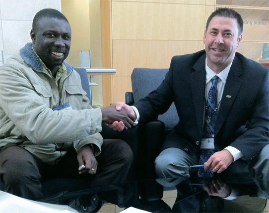 CAUT president Wayne Peters (right) shakes hands with Christian Addai-Poku, president of Ghana’s National Association of Graduate Teachers, after signing a mutual cooperation agreement.